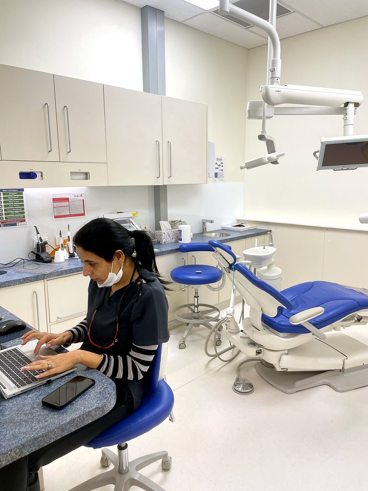 Dr Simran planning treatment at the chairside desk