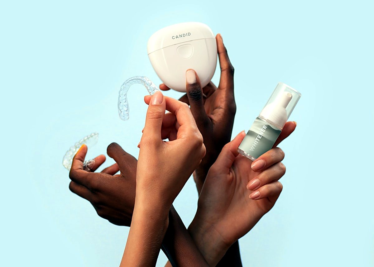 A clear aligner tray held in the hand