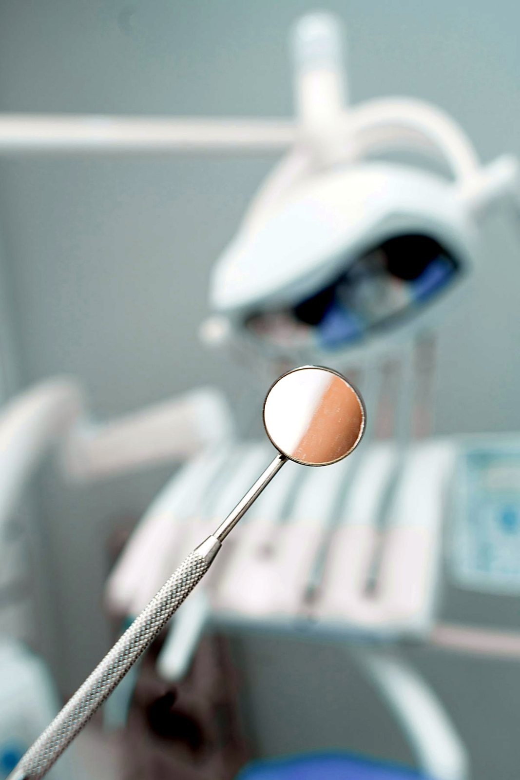 A dental treatment light and mirror in a calm surgery