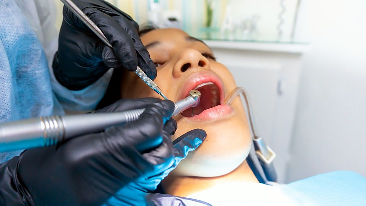 A dentist attending to a patient during treatment