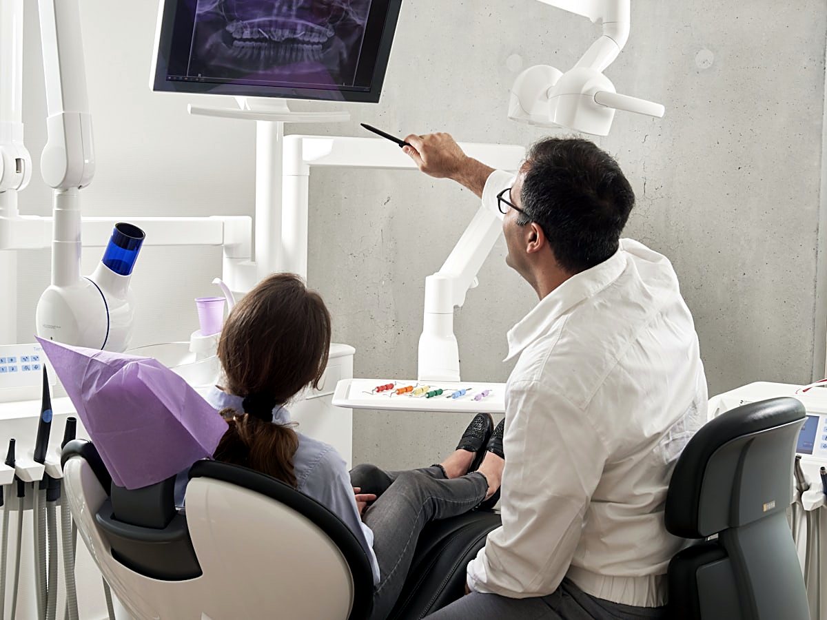 A dentist treating a patient in a modern surgery
